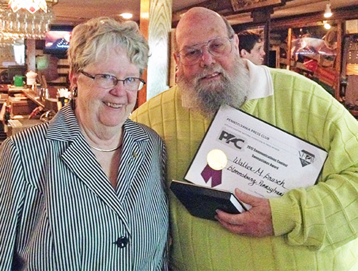 Walter Brasch won the 2012 Pennsylvania Press Club Sweepstakes Award, and was also honored as “Communicator of the Year.” With him at the 2012 awards luncheon at the Farnsworth Tavern in Gettysburg is Pennsylvania Press Club President Pat Ryder. (Kim de Bourbon)