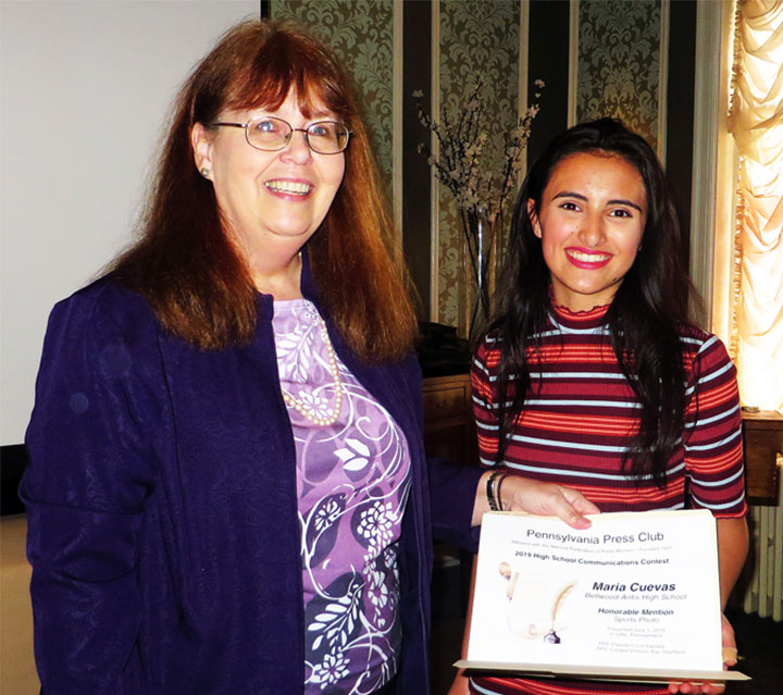 Kay Stephens presents Bellwood-Antis High School student Maria Cuevas an award for her sports photo at the June 1, 2019 PPC Awards Luncheon.